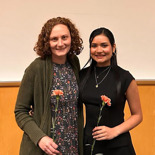 Talia and Naely holding roses for a picture